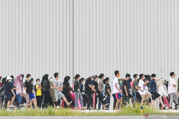 Sejumlah Warga Negara Indonesia (WNI) yang dievakuasi dari Wuhan, Hubei, China melakukan senam bersama prajurit TNI pada hari kesembilan di Hanggar Pangkalan Udara TNI AU Raden Sadjad, Ranai, Natuna, Kepulauan Riau. ANTARA FOTO/M Risyal Hidayat/hp.